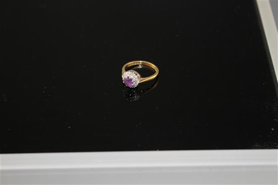 A modern 18ct gold, amethyst and diamond set circular cluster ring, size I, gross weight 3.2 grams.